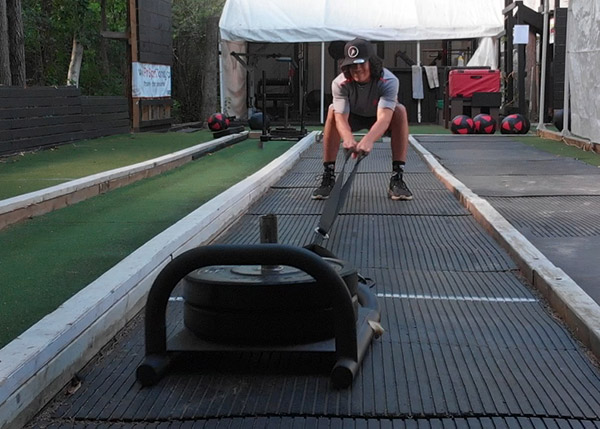 an image of an athlete pulling a weighted sled